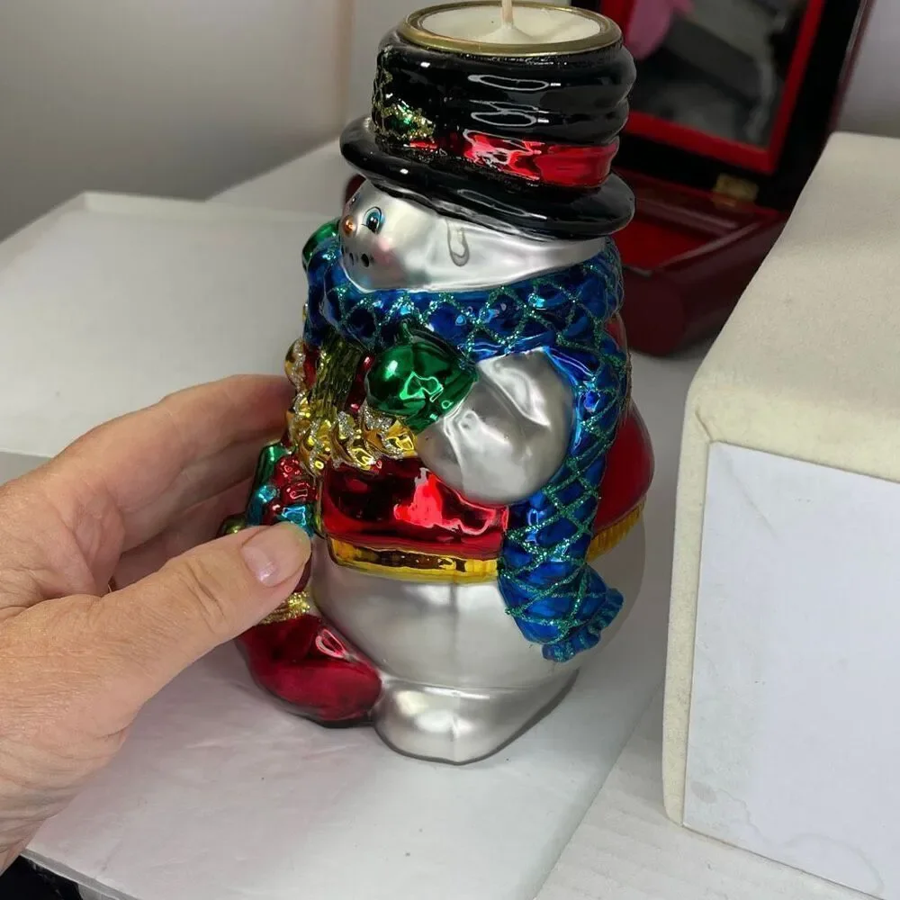 Charming hand-blown mercury glass snowman candle holder.